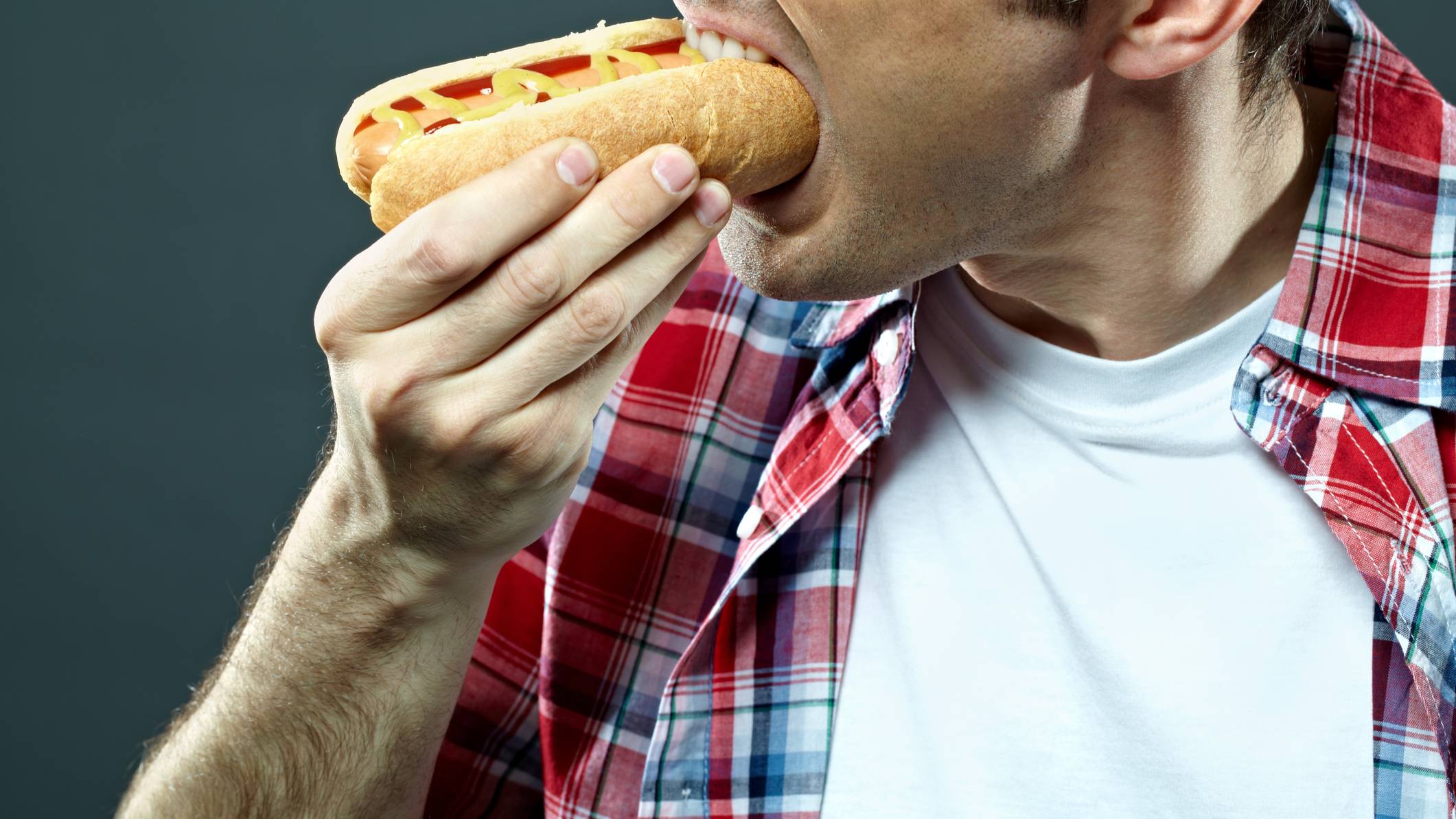 man eats hotdog