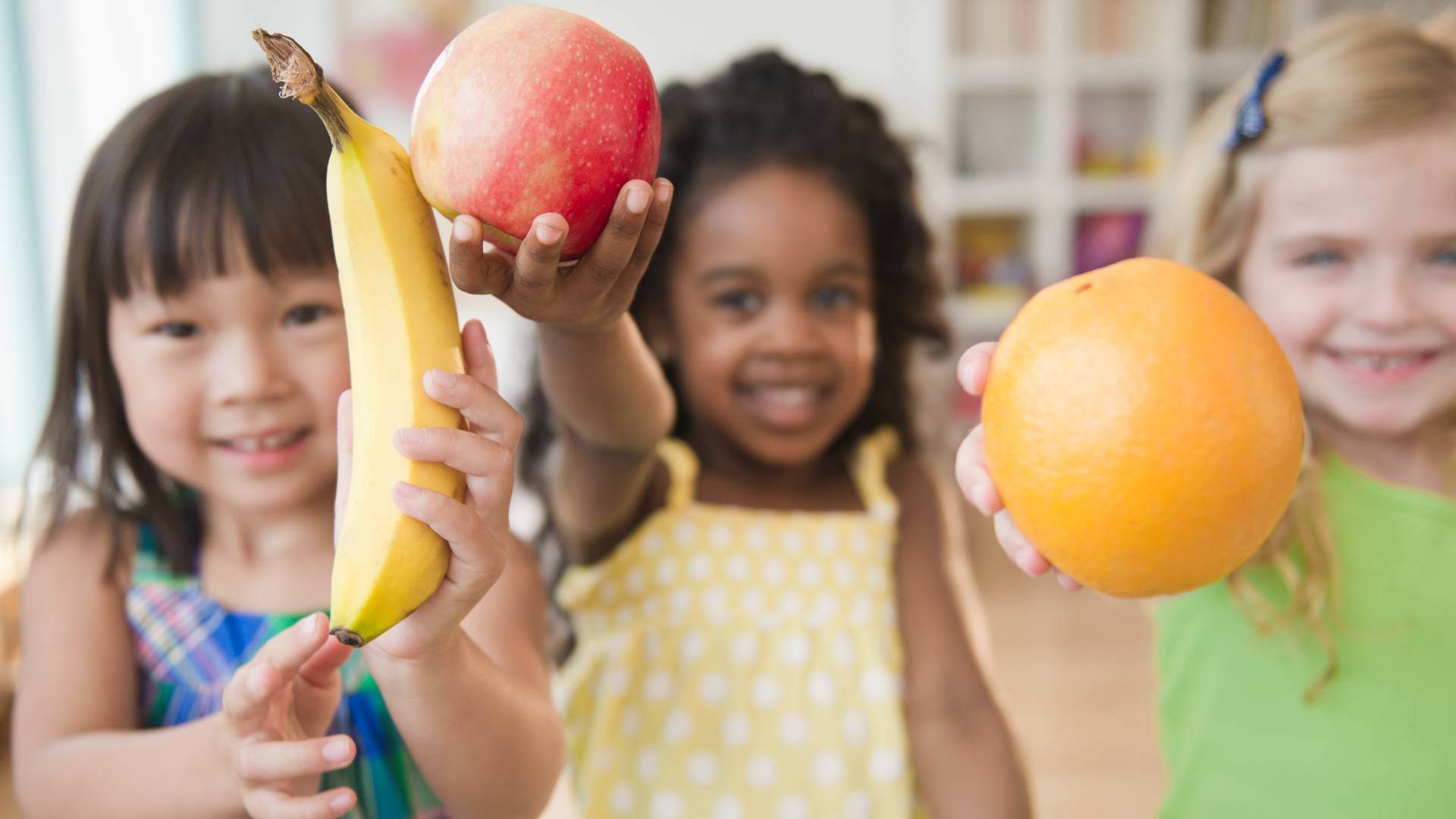 happy schoolkids with fruit