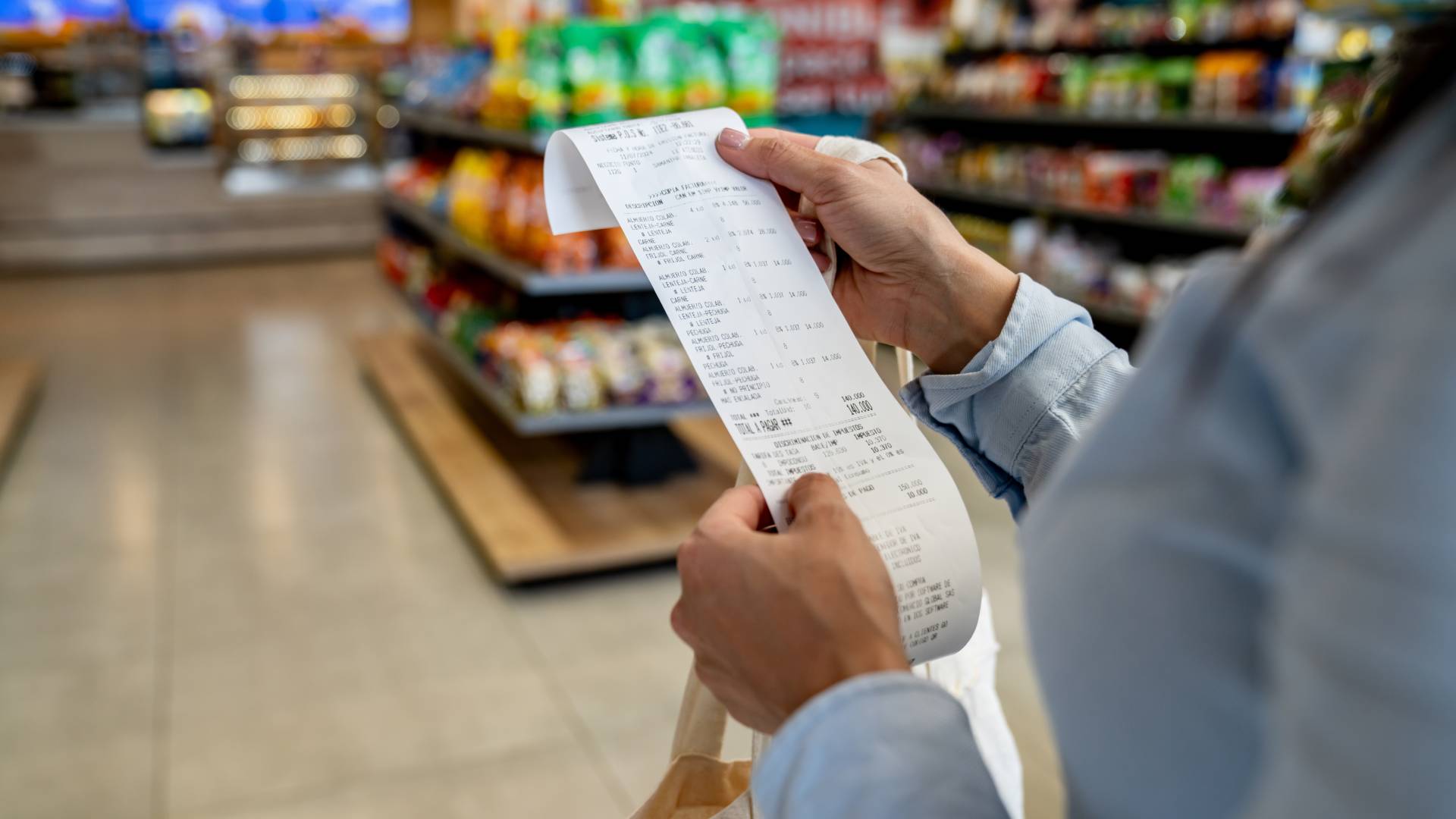 holding grocery receipt