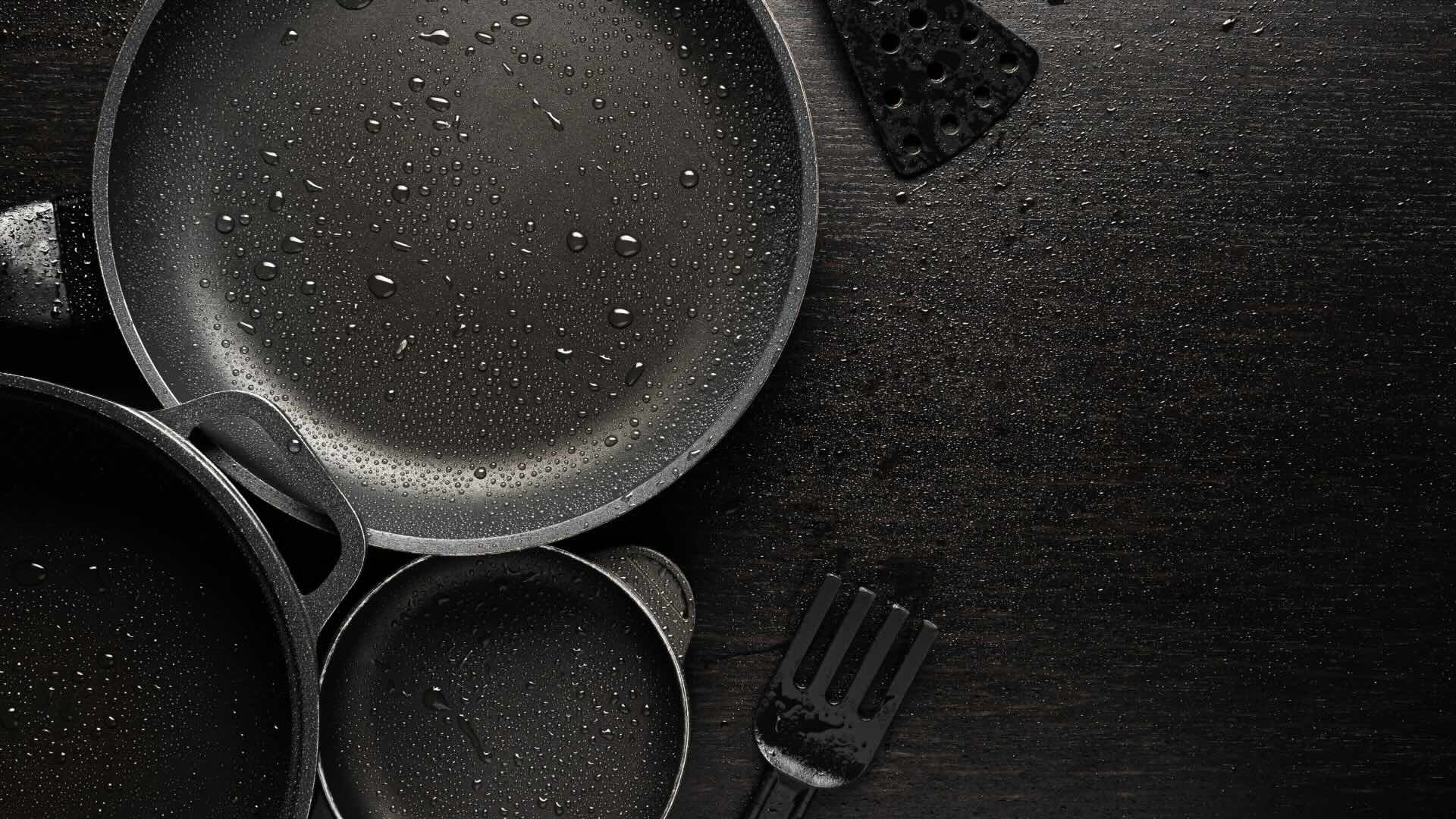  Black frying pans with a non-stick teflon coating