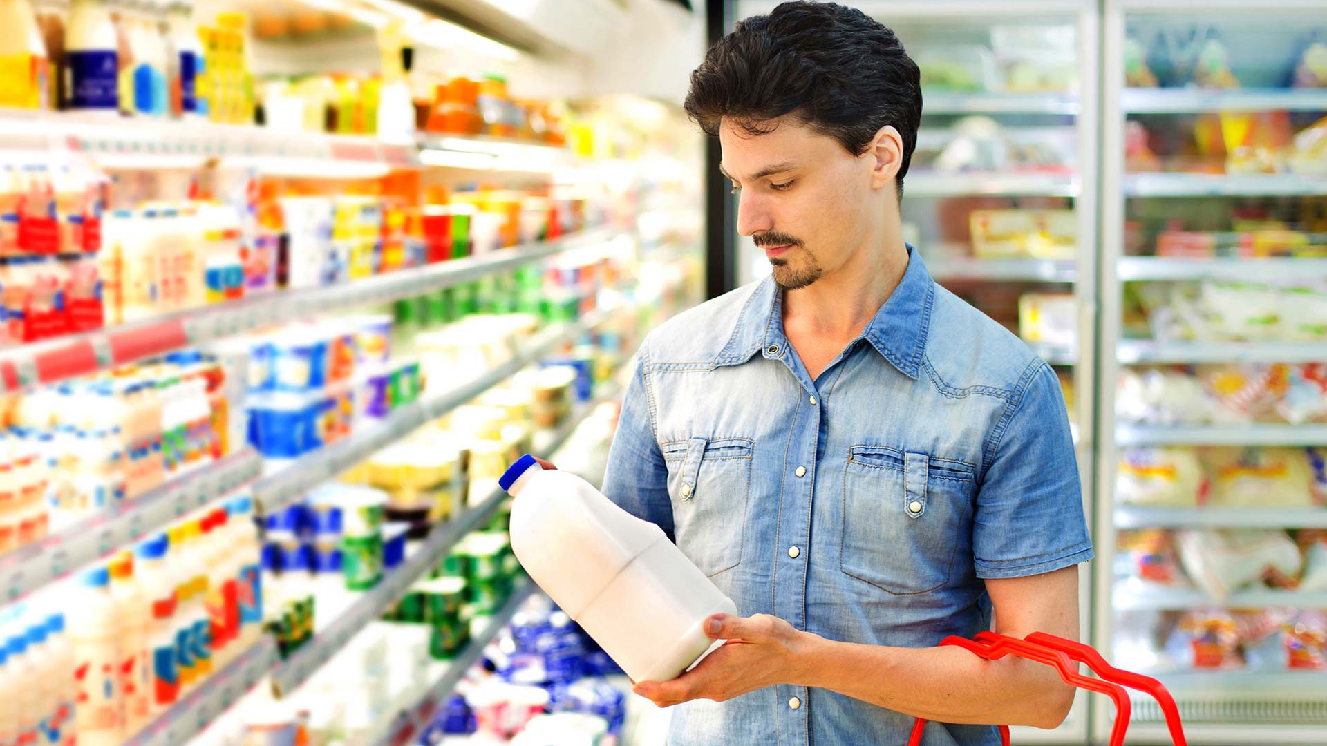 Man looking a milk in grocery store