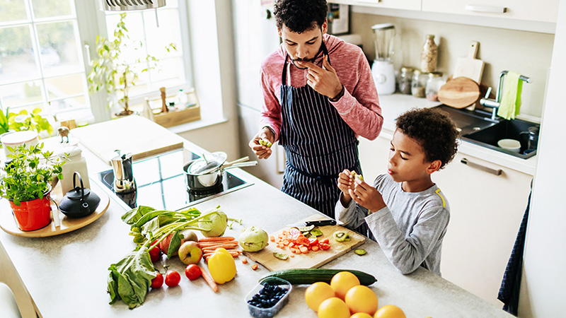 Parent and child cooking vegetables