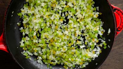 Heat 1/2 cup water in skillet. Add onion and bell pepper and sauté until cooked through.