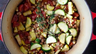 Agregar el maíz, los frijoles, los tomates y su líquido, y el tomillo. Cubrir